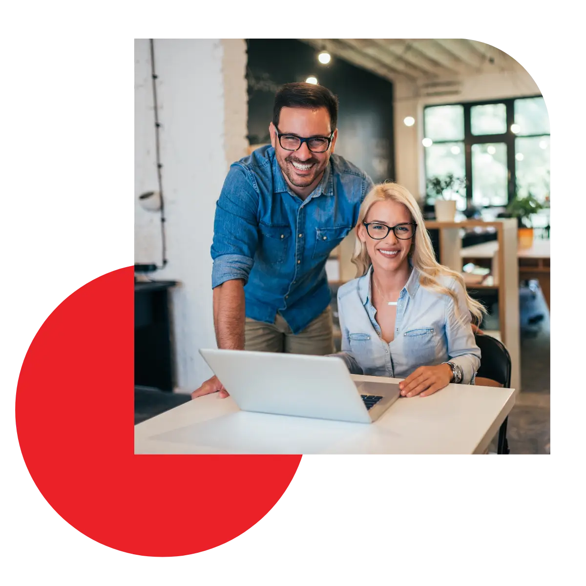 Smiling business partners at a laptop learning how to become a better owner.