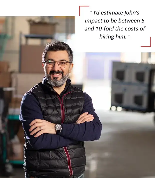 Business coaching client in a warehouse with testimonial about coaching impact